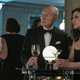 Jean-Luc Picard and Supervisor Tallinn share drinks at a black-tie event.